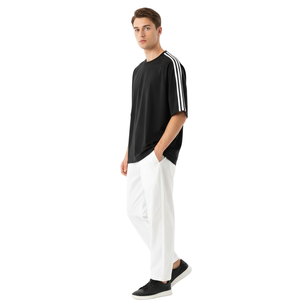 Man wearing a black t-shirt with white stripes and white pants on a white background